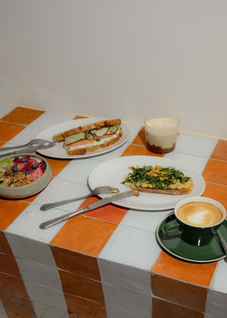 Mesa con cafés, tostadas y bol de desayuno